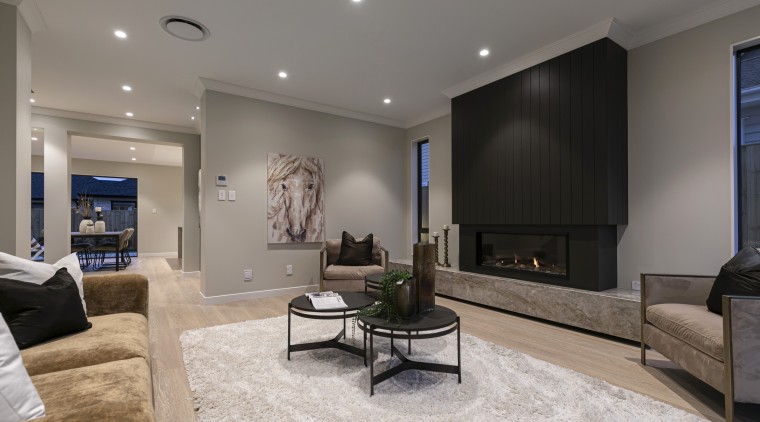 The room-height fireplace surround creates a leading interior 