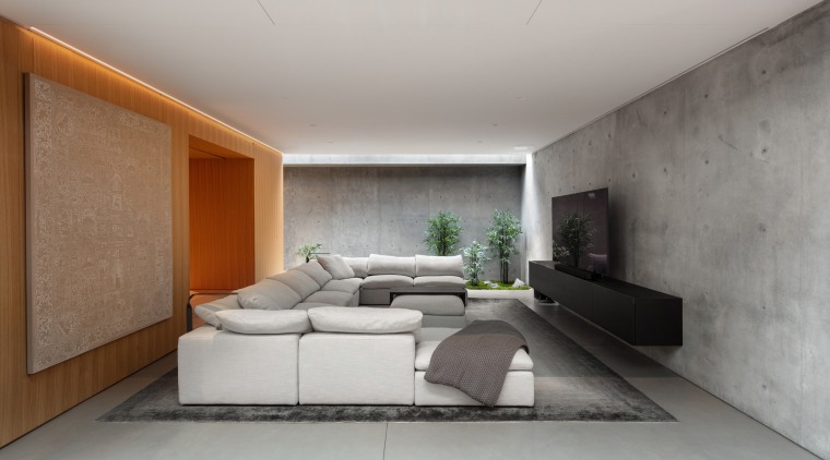 The dramatic media room features walls of concrete 