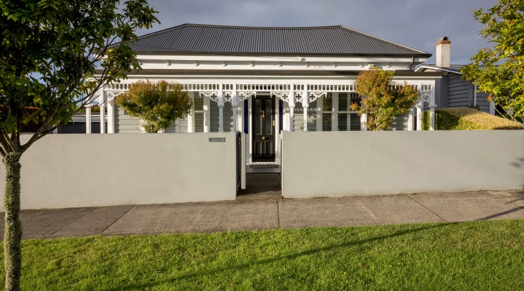The front of this traditional villa was faithfully architecture, building, estate, facade, grass, home, house, lawn, mansion, property, real estate, residential area, roof, sky, tree, villa, yard, brown, gray