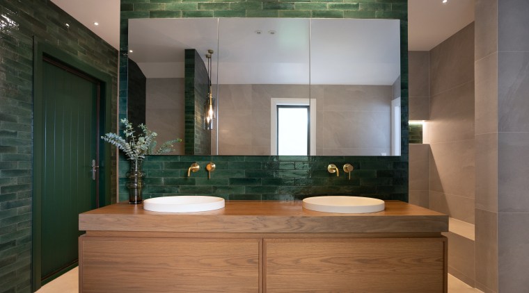 The bespoke oak timber vanity, with mirror reflecting 