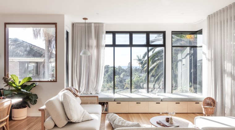 Consecutive vertical windows above the daybed frame the 