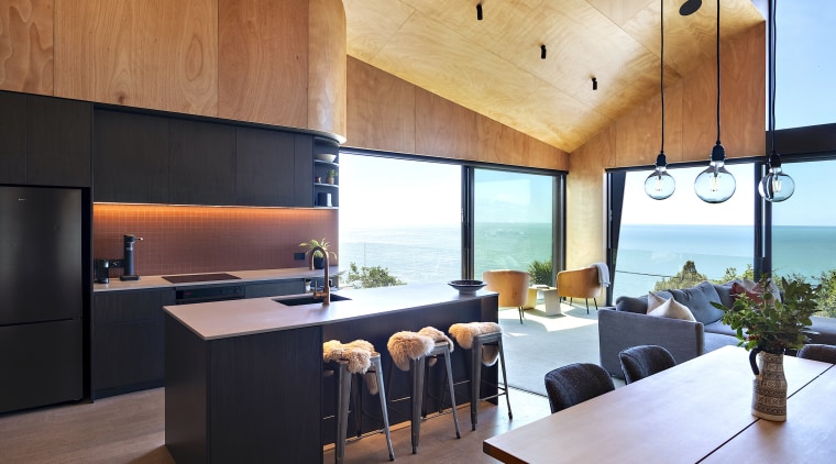 Integrated appliances and handleless joinery reduce visual clutter 