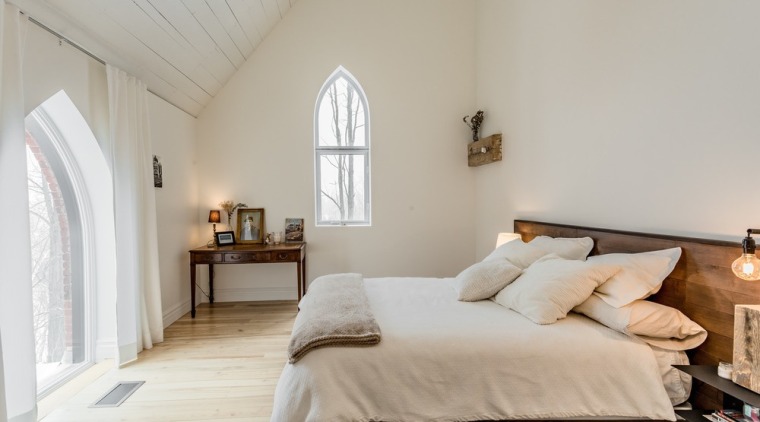 The design combines two very important criteria – architecture, attic, bed, bed frame, bed sheet, bedding, bedroom, building, ceiling, comfort, daylighting, estate, floor, flooring, furniture, hardwood, home, house, interior design, mattress, property, real estate, room, suite, wall, wood, wood flooring, gray