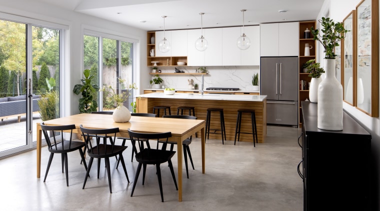 Polished concrete floors and white kitchen cabinetry both 