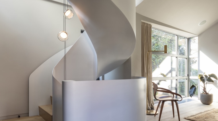 The steel stair spirals right up through the 