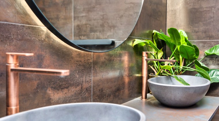 Concrete above-counter bowls also add to the ensuite's 