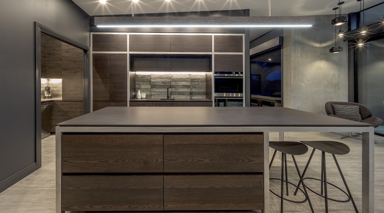 Dark-toned and linear, this kitchen matches the character gray, black