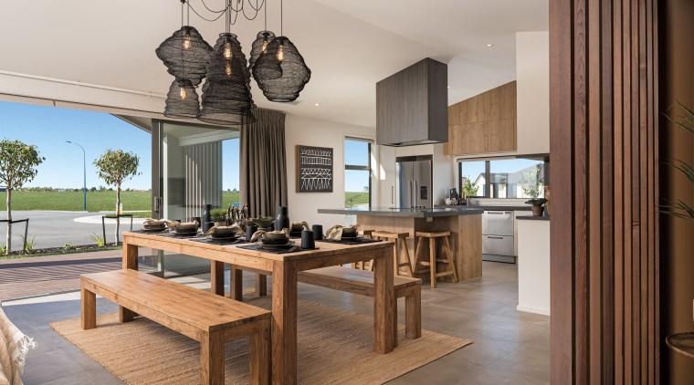 ​​​​​​​This generous family-dining-kitchen area in a GJ Gardner gray, brown