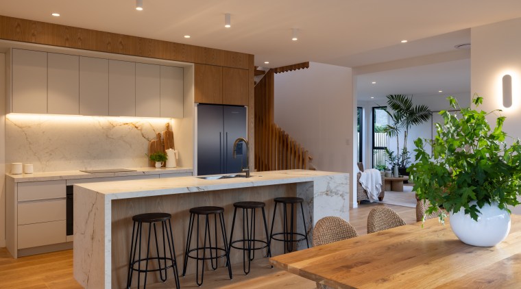 Overhead cabinetry and concealed storage ensure everyday essentials 