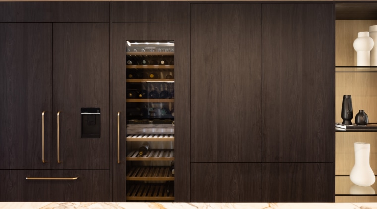 The wine fridge is integrated into the cabinetry 