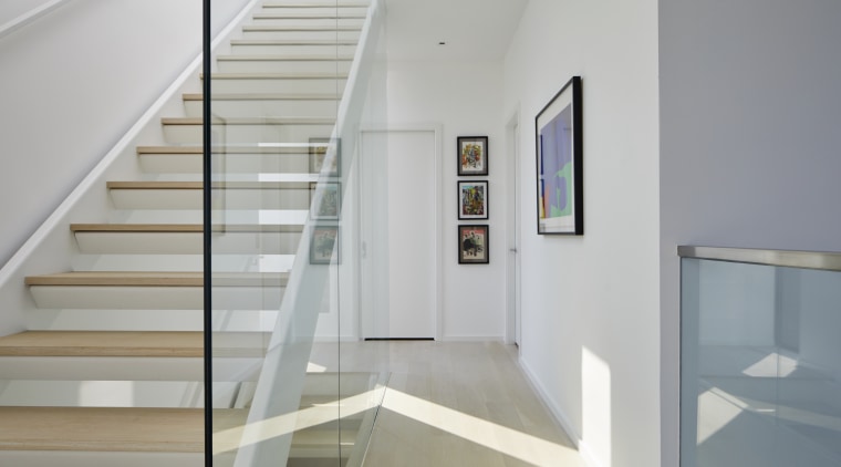 The main staircase complete with feature glass balustrade. 