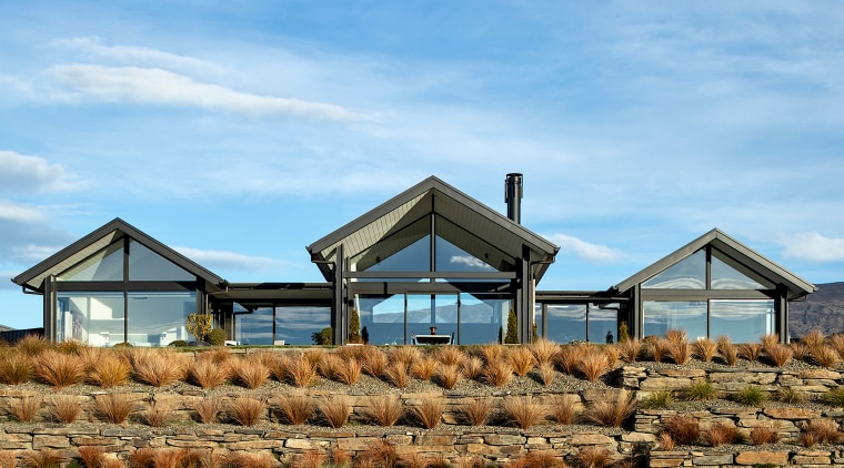 Staggered landscaping steps the house into its rugged 