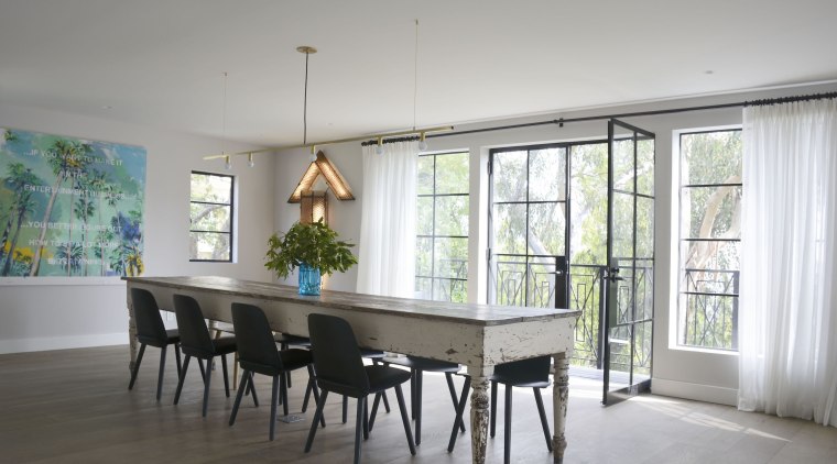 The suitably rustic dining table is surrounded by 