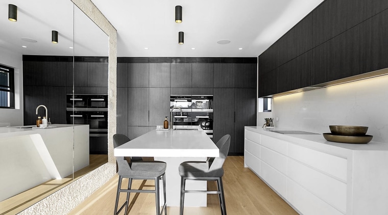 Black and white kitchen surfaces are grounded by 