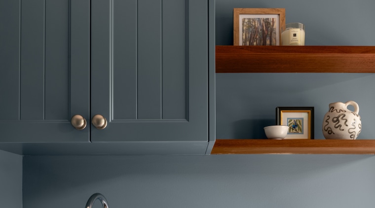 The laundry cabinetry echoes the board look-fronted cabinets 