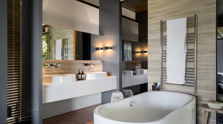 Travertine-look tiles on the floor of this renovated bathroom, interior design, room, gray, black