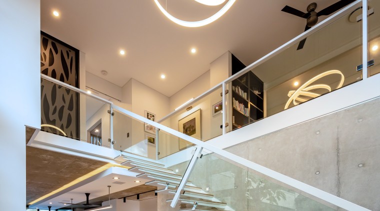 ​​​​​​​A dramatic pendant draws attention to the scale apartment, architecture, ceiling, daylighting, handrail, home, house, interior design, lobby, stairs, gray