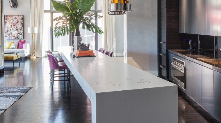 This Corian counter angles away from the kitchen, countertop, cuisine classique, floor, flooring, interior design, kitchen, loft, table, gray