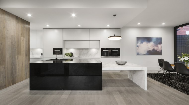 While packing a punch in terms of functionality countertop, timber floor, flooring, interior design, kitchen, laminate flooring, tile, wood flooring, black, LSA Architects