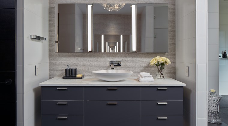 Set directly opposite each other, the wall-hung, mirror-fronted bathroom, bathroom accessory, bathroom cabinet, cabinetry, countertop, floor, interior design, kitchen, room, sink, gray, black