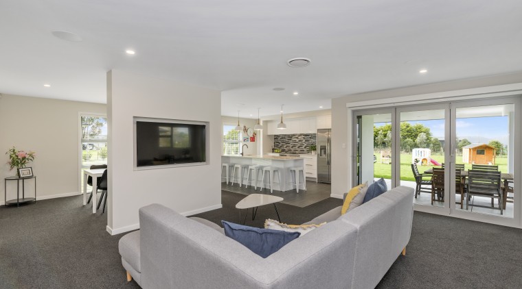 This award-winning home’s spacious living zone connects to estate, interior design, living room, property, real estate, gray