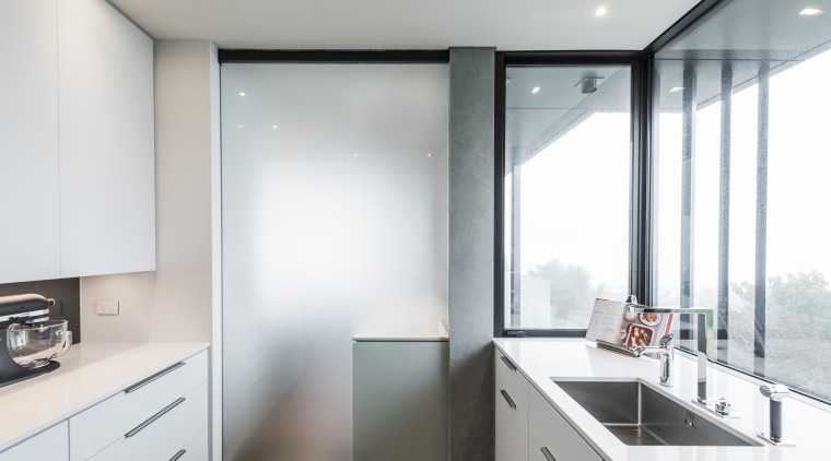In this kitchen, a frosted glass door can architecture, countertop, house, interior design, kitchen, real estate, window, white, gray