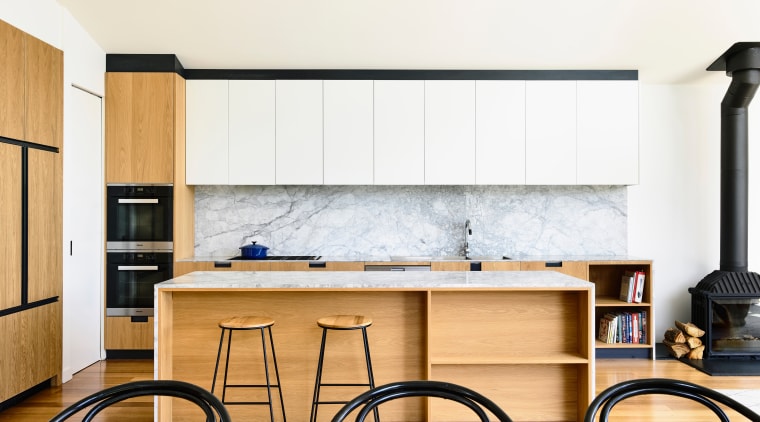 ​​​​​​​Understated design can also stand out.This minimalist entertainer’s cabinetry, furniture, kitchen, wall, white, Contemporary, kitchen island, Porter Architecture