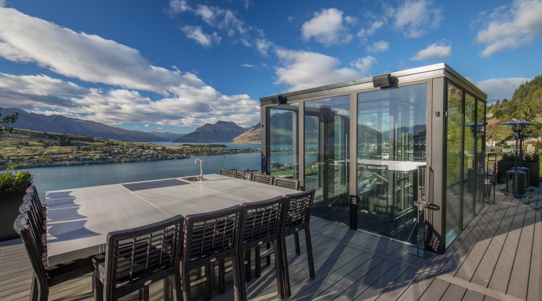Visitors riding in this Queenstown home’s glass-walled elevator Gary Todd Architecture, home, house, lakeside home,  water views, Queenstown