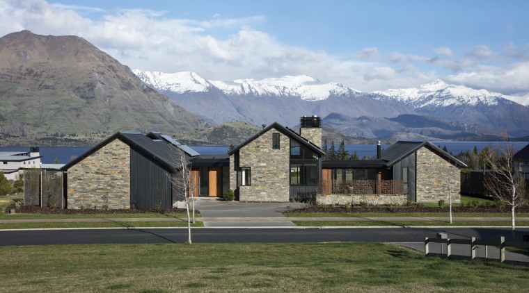 ​​​​​​​The triple peaks of this pavilion home by alps, highland, hill, home, house, andscape, roof, stone, timber, Condon Scott Architects, schist, cladding