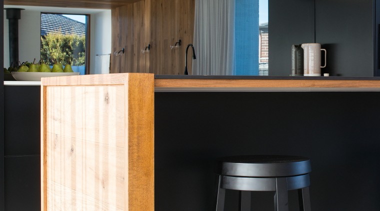 ​​​​​​​Mirror splashbacks add to the sense of space architecture, bar stool, kitchen, timber, glass splashback, stool, table, wood, wood stain, black, impact kitchens