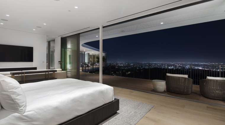 ​​​​​​​At night, large sliding glass panels open this home, house, architecture, bedroom, black-and-white, design, floor, flooring, furniture, home, house, interior design, lighting, open living, sliding glass panels, city views, spfa