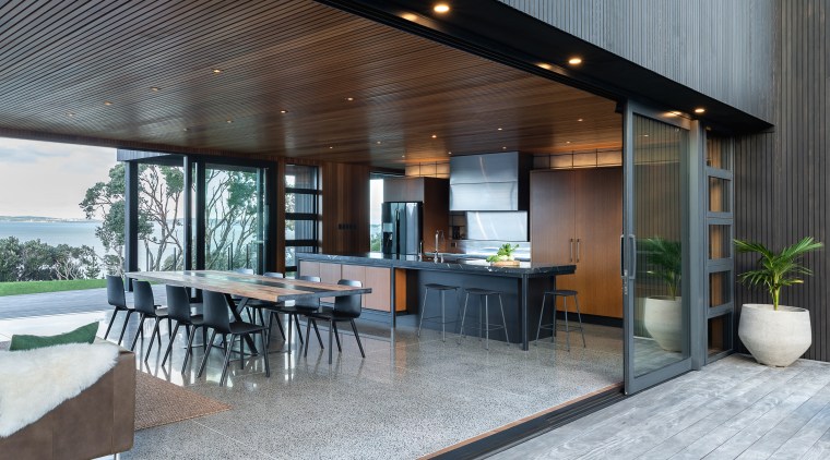 ​​​​​​​Context is everything. This kitchen connects with and architecture, backyard, building, ceiling, deck, design, estate, floor, flooring, furniture, home, house, interior design, landscaping, patio, porch, property, real estate, roof, room, table, gray, black