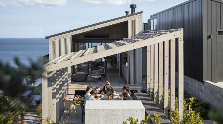 The outdoor dining space, situated under the pergola, 