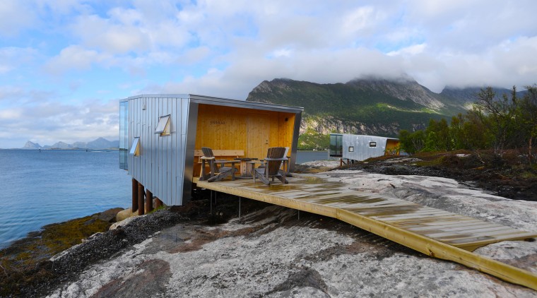 The new cabins at Manshausen Island Resort by coast, geological phenomenon, highland, house, mountain, sea, sky, transport, yellow, teal
