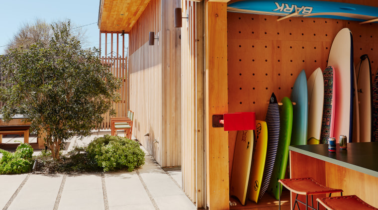 A customised surfboard storage unit and garage provide 