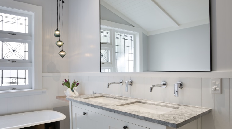 The owner had wanted a traditional look with bathroom, bathroom accessory, bathroom cabinet, cabinetry, countertop, floor, home, interior design, kitchen, room, sink, gray