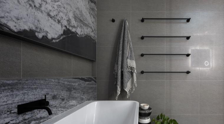 The bathroom's feature porcelain sheet, stone-look back wall 