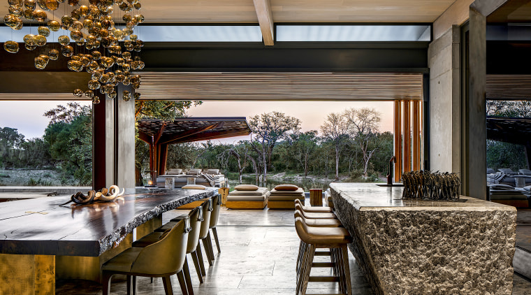 This Pierre Cronje dining table,  made from a architecture, backyard, building, ceiling, dining room, estate, furniture, home, house, interior design, landscaping, lighting, patio, porch, property, real estate, residential area, room, shade, table, tree, black, brown, white