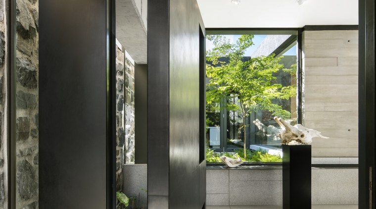 The substantial pivot front door swings into the 