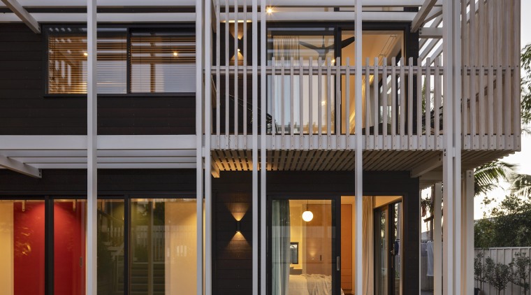 Dark stained timber weatherboards are contrasted with white-washed 