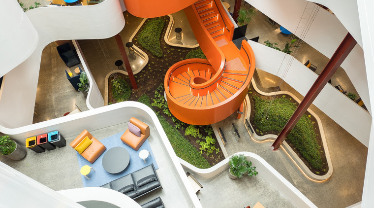 The vibrant, spiral staircase in the atrium of white