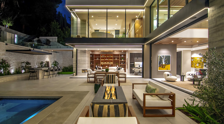 The luxury resort-style home features giant sliding glass 