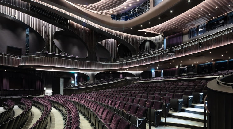 Conceived as a cultural sanctuary, the performance venue architecture, audience, auditorium, building, ceiling, concert hall, convention center, heater, interior design, musical instrument accessory, opera house, orchestra pit, performing arts center, stage, theatre, black