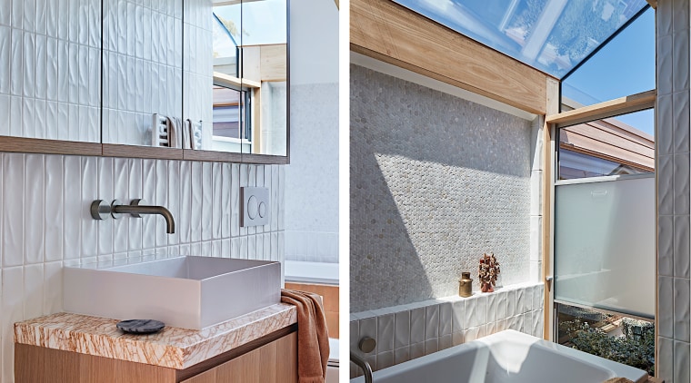 The warm, texture-rich bathroom is flooded with natural 