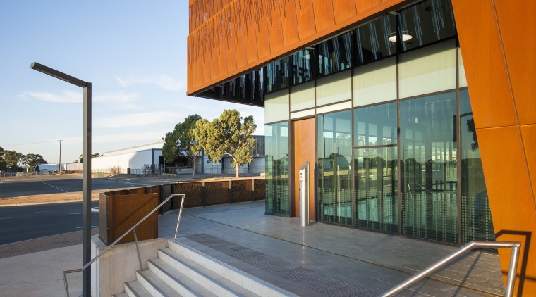 The lower section of the weathered steel facade architecture, building, commercial building, condominium, corporate headquarters, daylighting, facade, house, line, real estate, reflection, sky, sunlight, brown