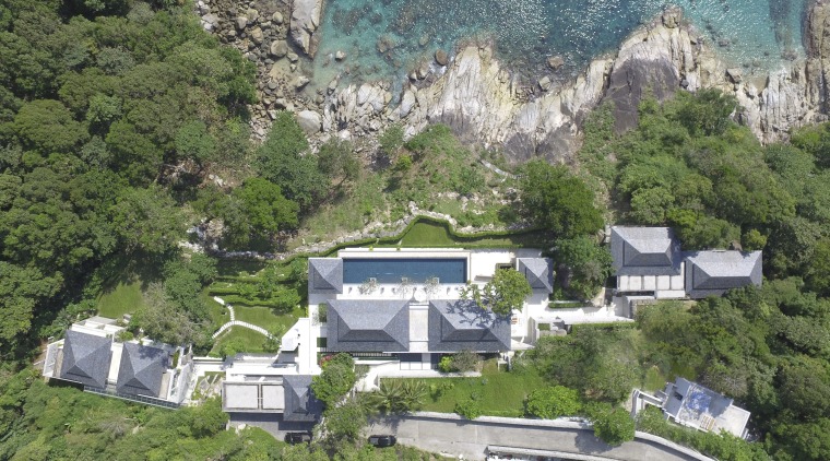 A steep drive leads down to this coastal aerial photography, bird's eye view, estate, geological phenomenon, hill station, home, house, mountain village, property, real estate, suburb, tree, village, green