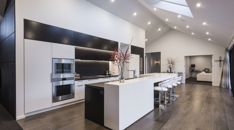A stepped countertop helps evoke the spatial features countertop, floor, flooring, interior design, kitchen, gray