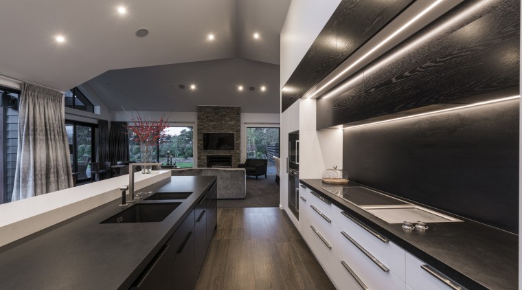 This kitchen by designer Davinia Sutton reflects the ceiling, countertop, interior design, kitchen, gray, black