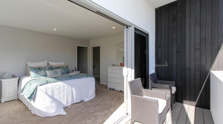 Stacker doors provide a seamless indoor-outdoor connection in bedroom, ceiling, floor, home, interior design, property, real estate, room, suite, wall, gray