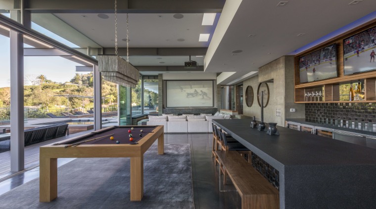 The dropped ceiling in this large, poolside entertaining interior design, real estate, table, gray, black